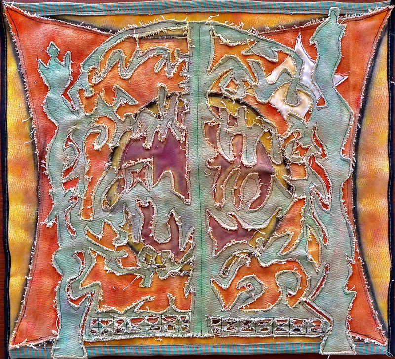 Two orange panels with teal cut-outs either side of a green seam