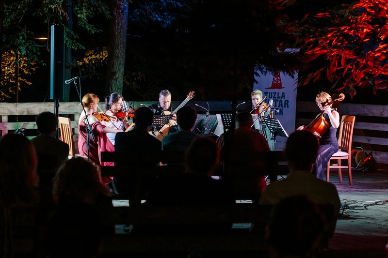 Musicians playing at night in the open air at Ilinčica, Tuzla